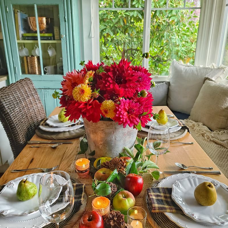 fall dahlias in a galvanized bucket and fruit for fall tablecscape