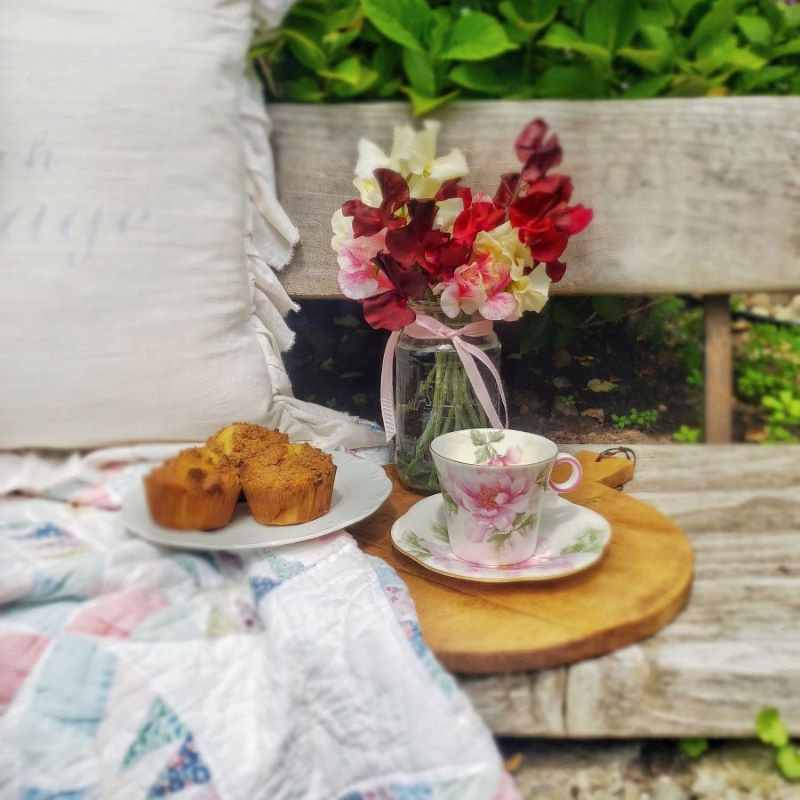 teacup and sweet peas outdoors