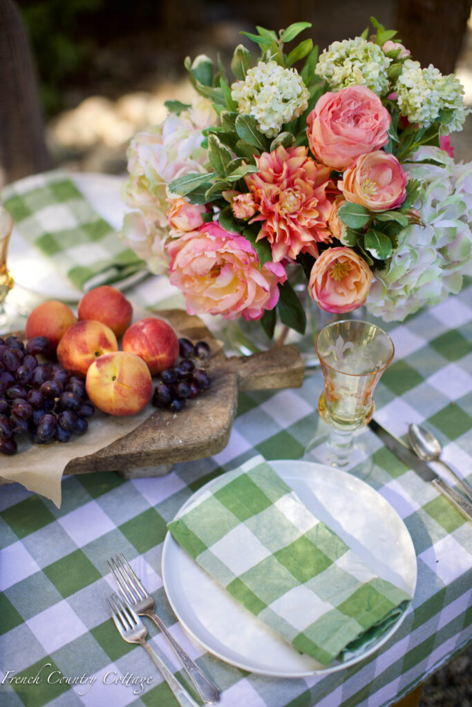table setting with floral arrangement and fruit