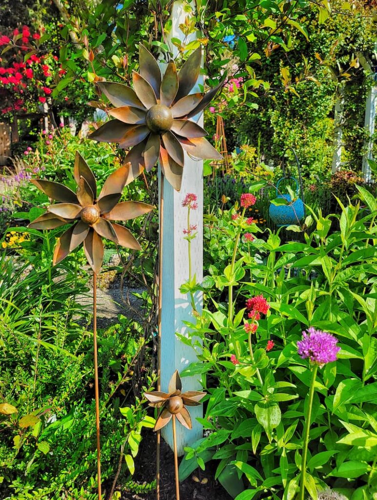 flower wind spinners in cottage garden