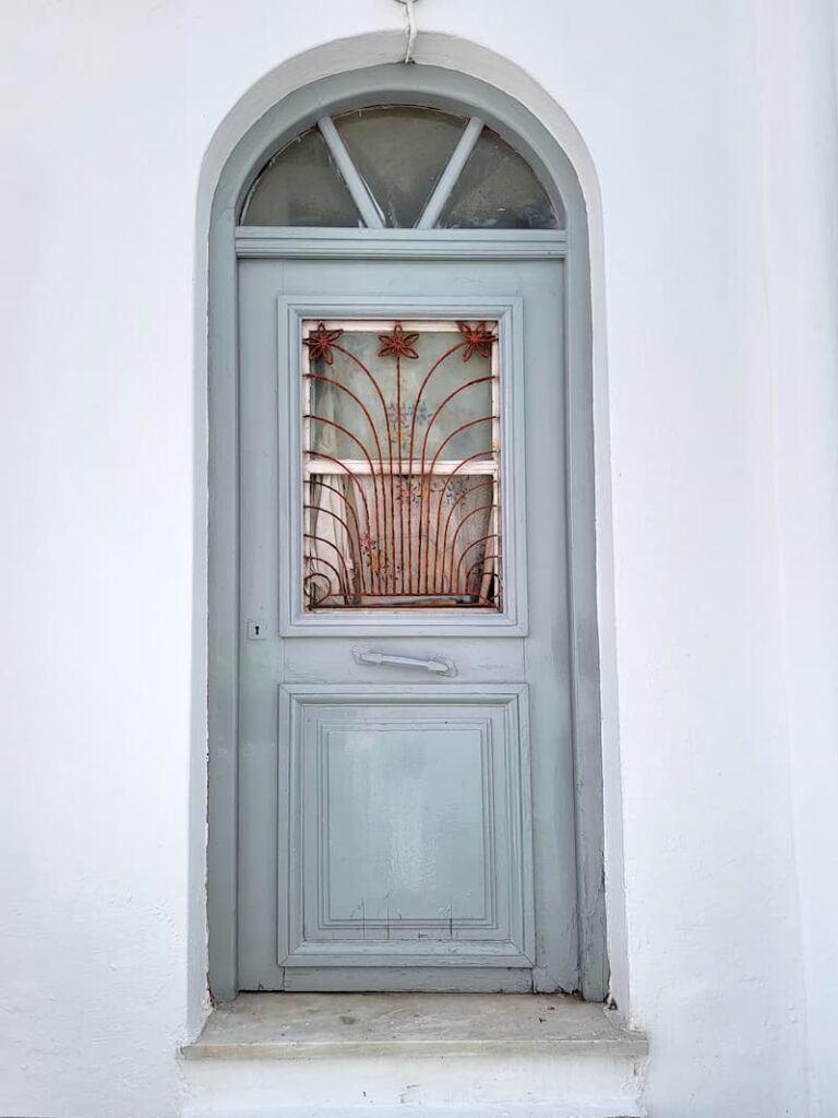 light blue vintage door with iron flower detailing
