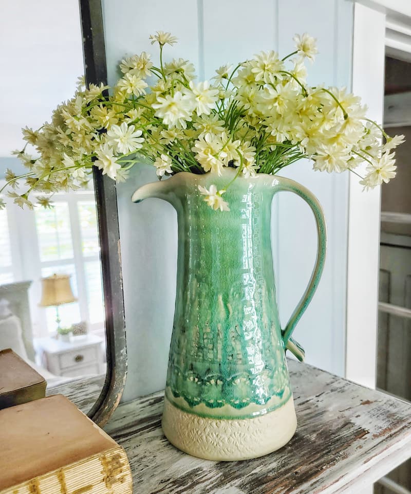 turquoise pitcher of faux flowers