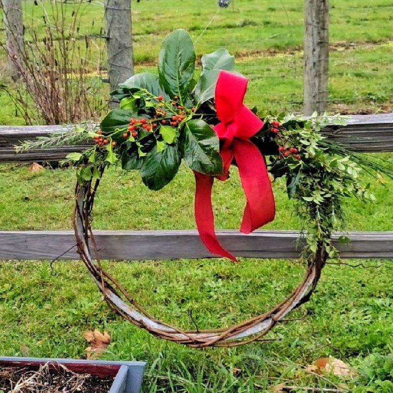 Christmas natural elements: fresh wreath with greenery and red bow