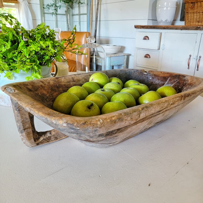 green apples in a rustic dough bowl