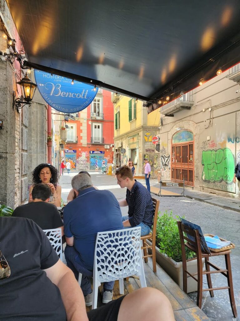 a restaurant located in an alleyway in Naples, Italy