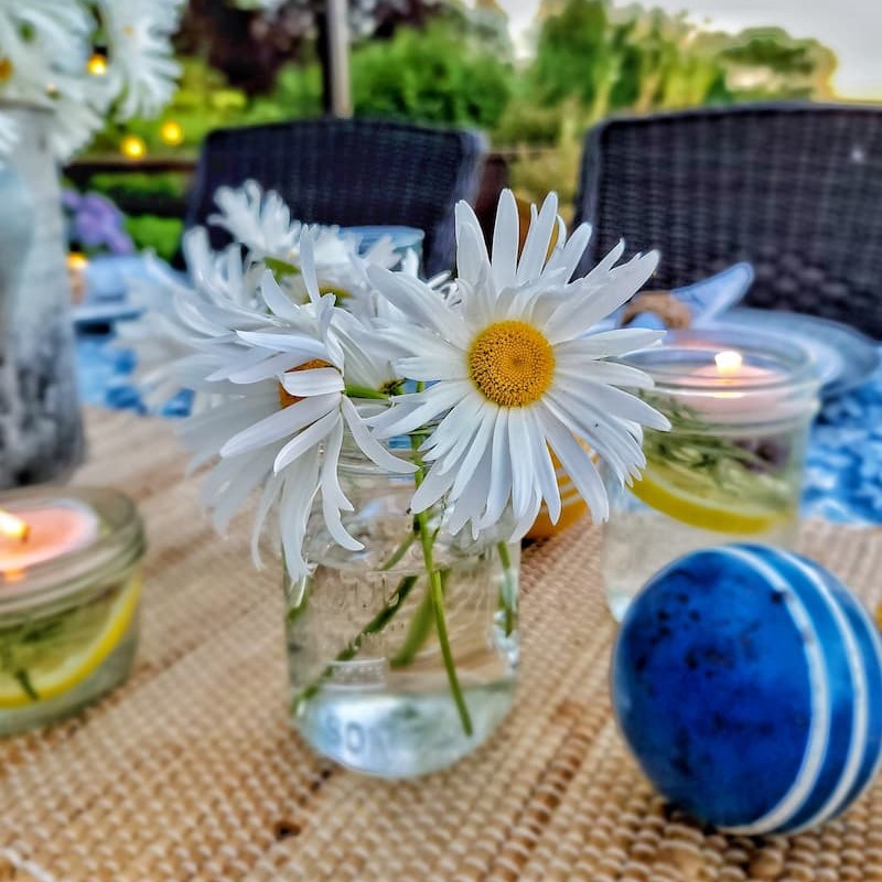candles, croquet balls and daisies for summer table centerpiece