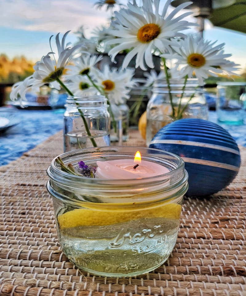 Summer tablescape ideas:  mason jar filled with floating candle, lavender and lemon slice