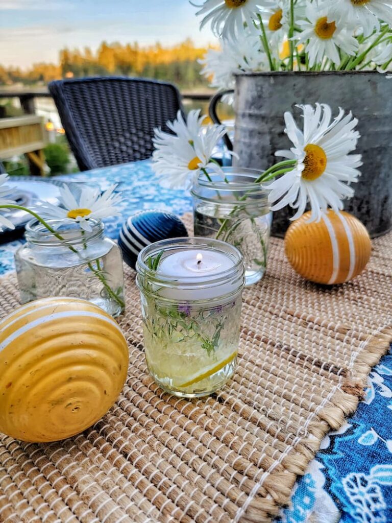 candles, croquet balls and daisies for summer table centerpiece