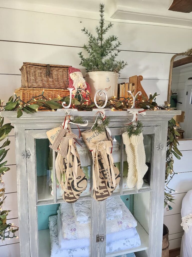 joy stocking holder with stocking hanging on a cabinet