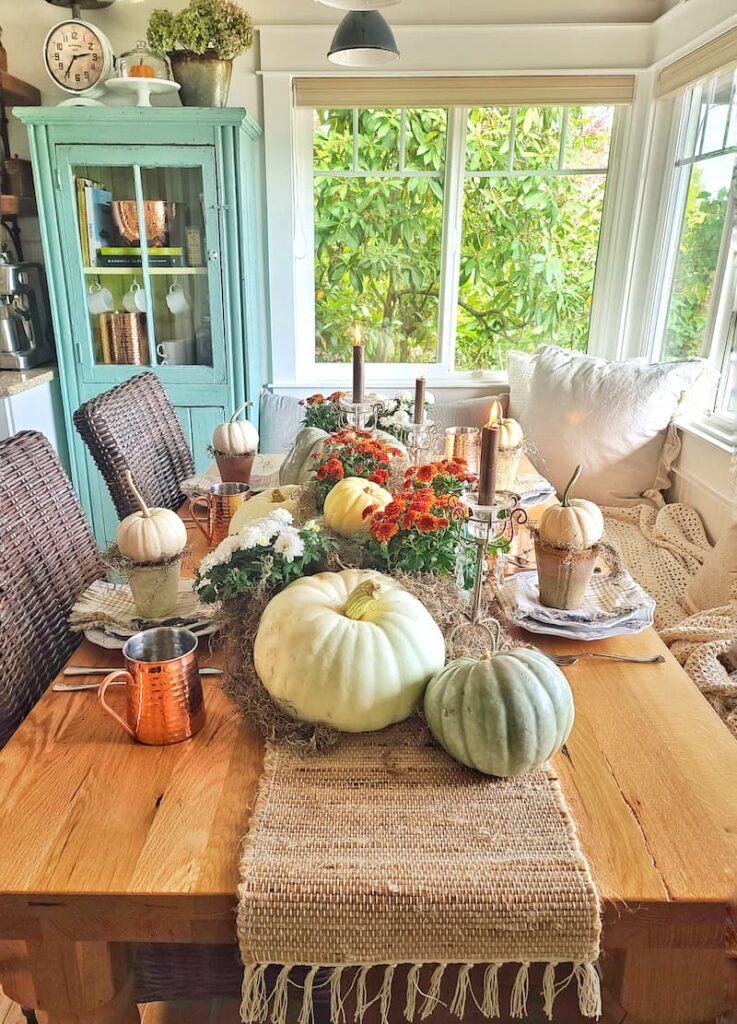 Fall table with pumpkins and mums