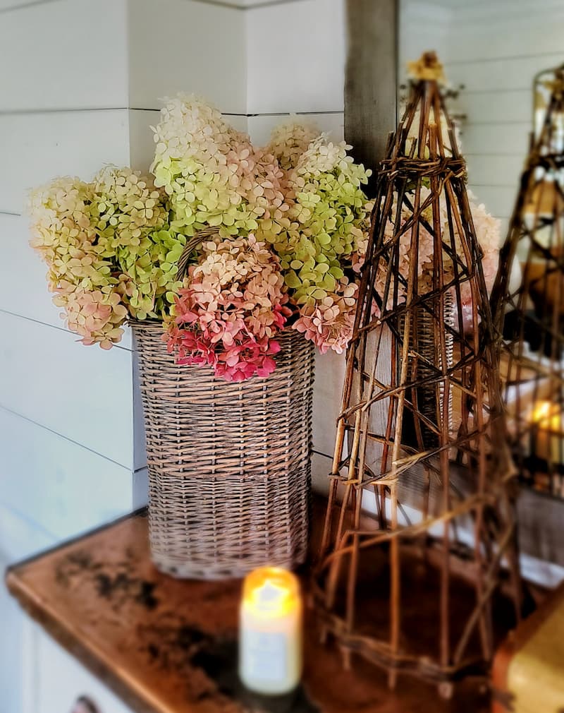 dried hydrangeas in basket and candle burning