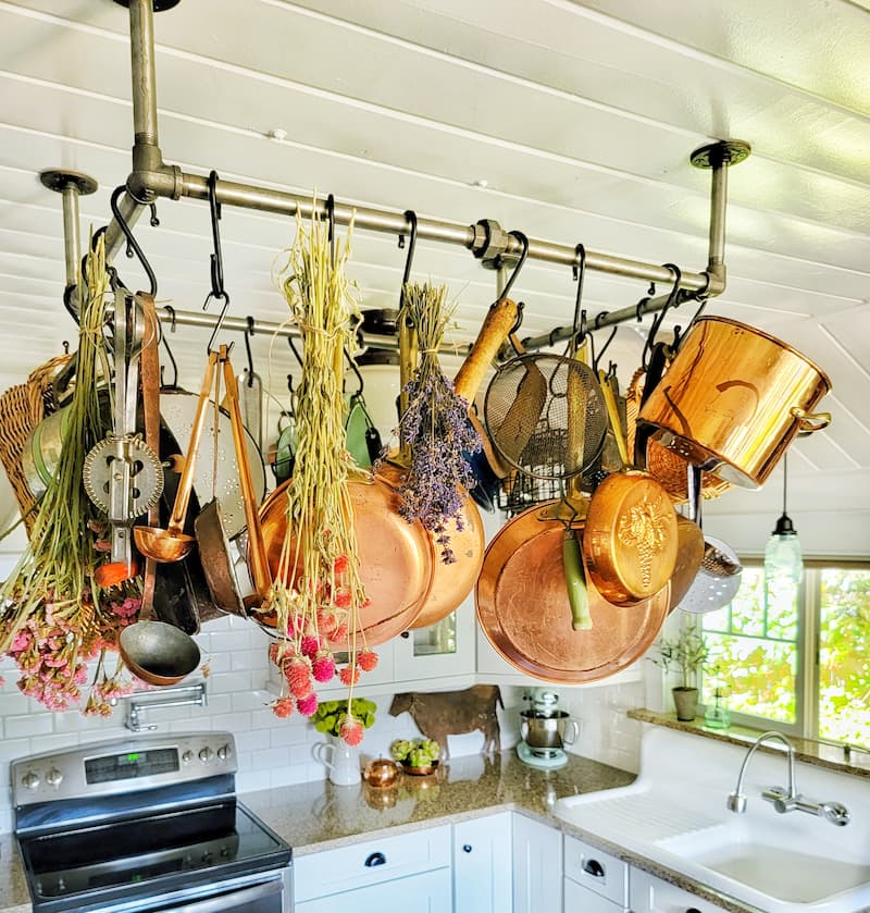 copper pots and pans on pot rack