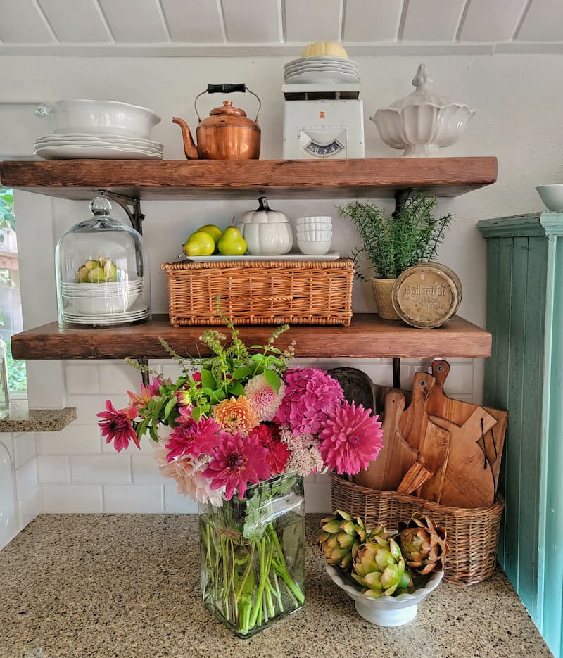 open shelving with fall decor and fresh seasonal flowers