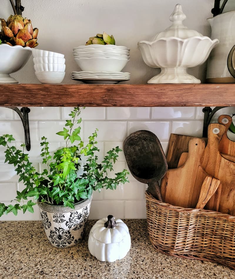 kitchen shelving with vintage white ironstone dishware, plant and basket with wood boards
