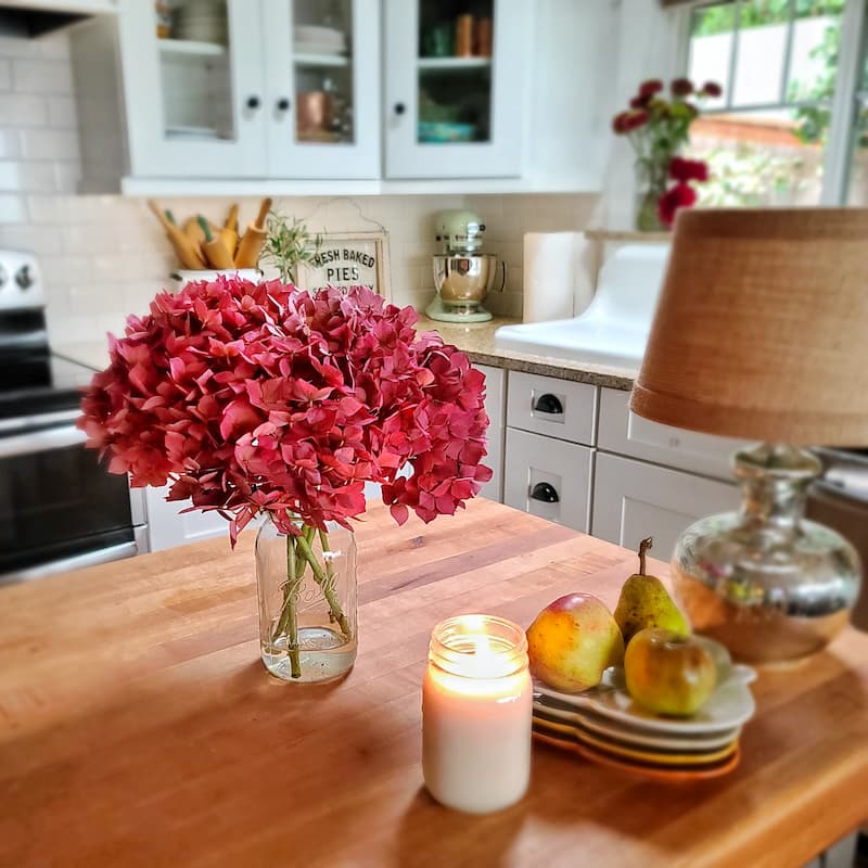 vase of hydrangeas and candle in fall kitchen