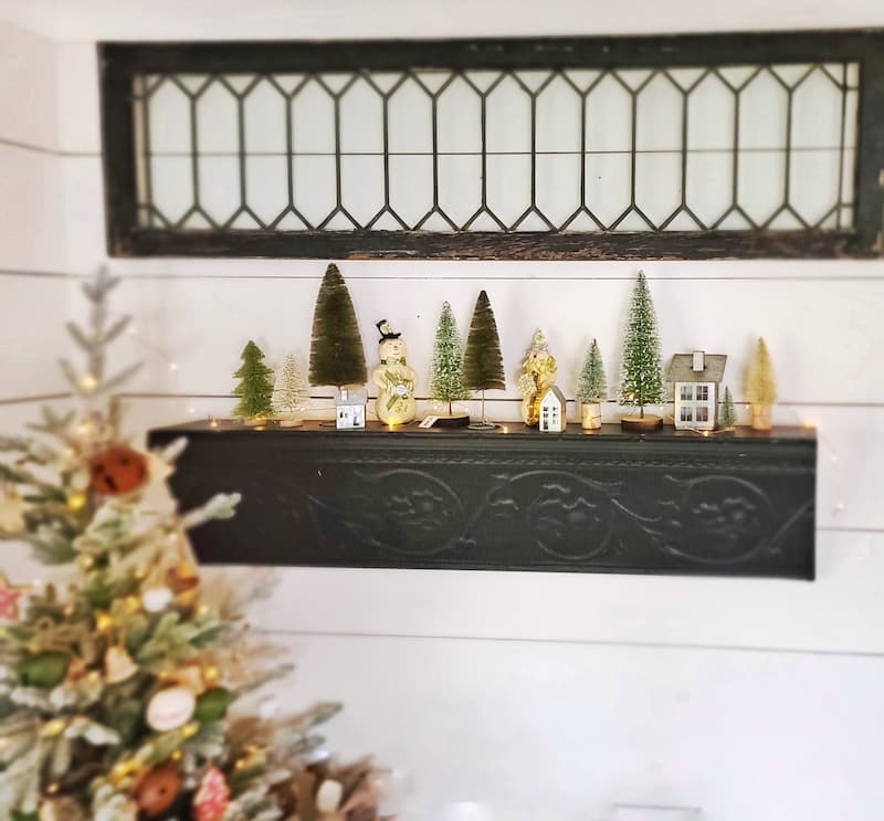 Cottage Christmas decor ideas: bottle brush trees on black shelf