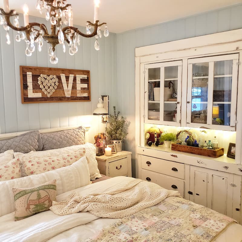 cottage bedroom with antique built-in cabinet