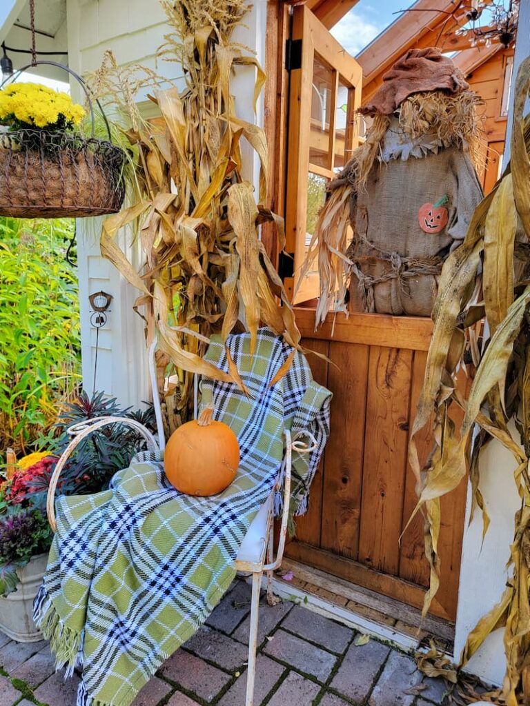 green and black plaid blanket on fall porch