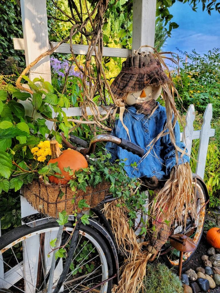 greenhouse fall decorating ideas scarecrow on a bike