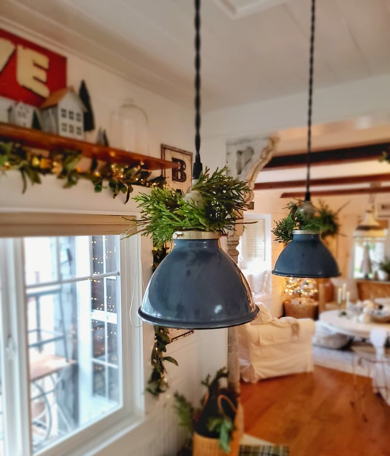 pendant light fixtures with greenery wrapped around 