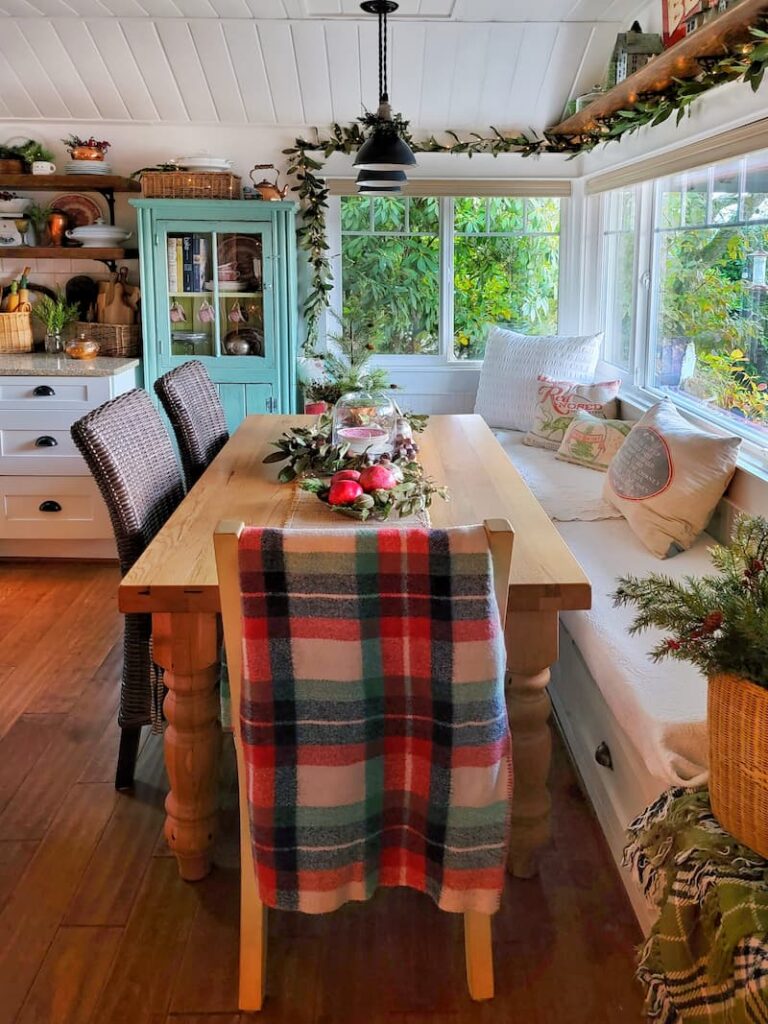 Christmas decor theme: kitchen eating area with plaid vintage blanket draped over chair