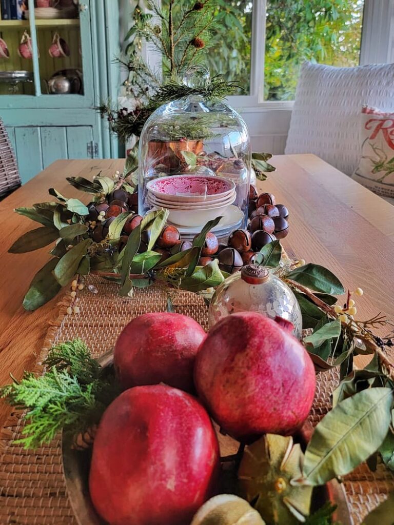 Christmas vignette with pomegranates and greenery