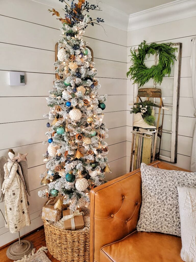 flocked decorated Christmas tree and vintage sled
