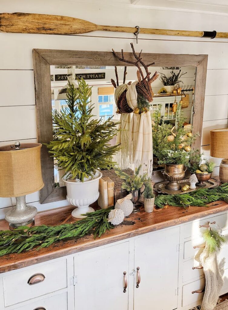 Cottage Christmas decor ideas: greenery, small tree and reindeer head