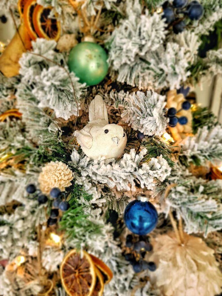 white bird on flocked Christmas tree
