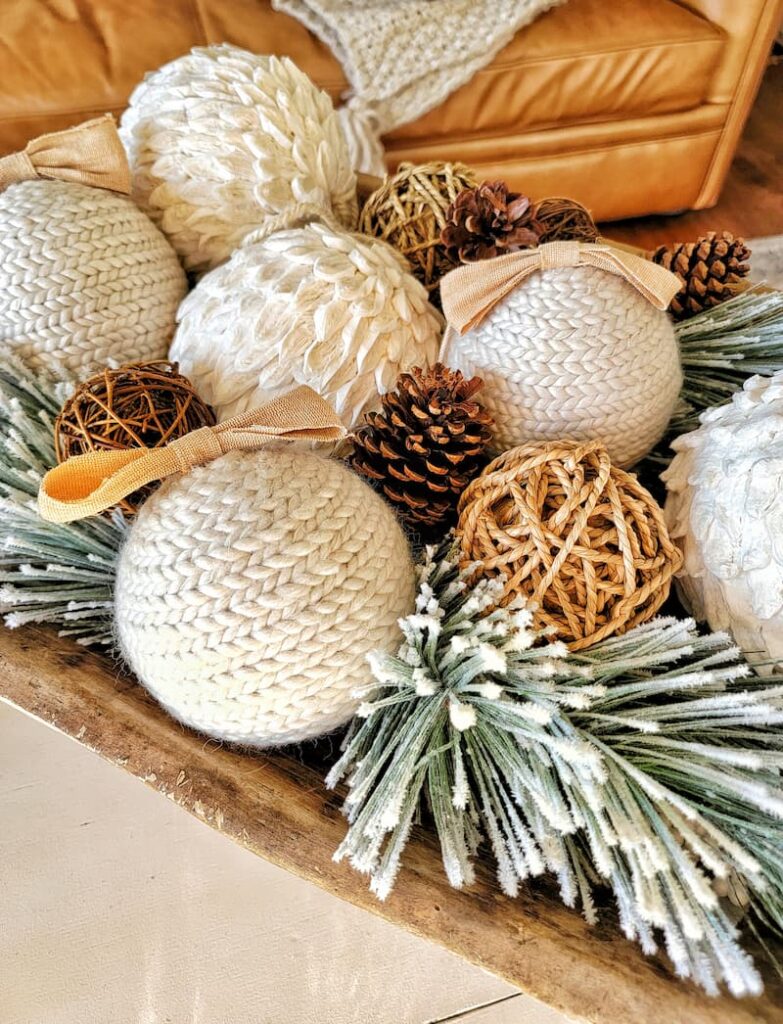 cream and twine ornaments with flocked greenery and pine cones
