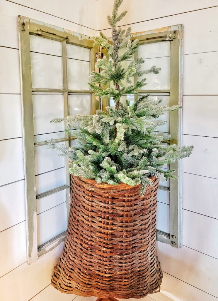 Cottage Christmas decor ideas: small faux Christmas tree in an oversized hanging basket