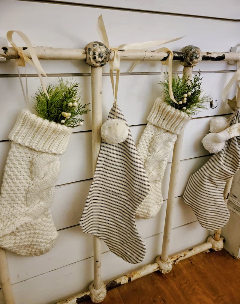 Cottage Christmas decor ideas: cream knit and ticking stockings hanging