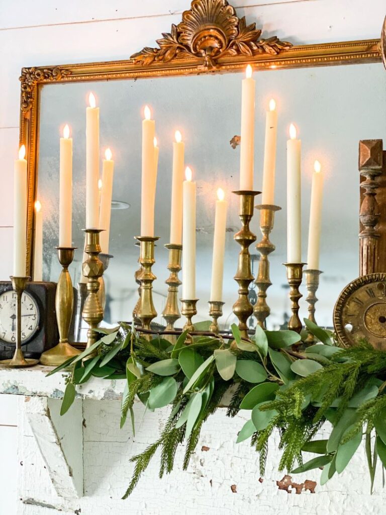 greenery garland and brass candlesticks with candles