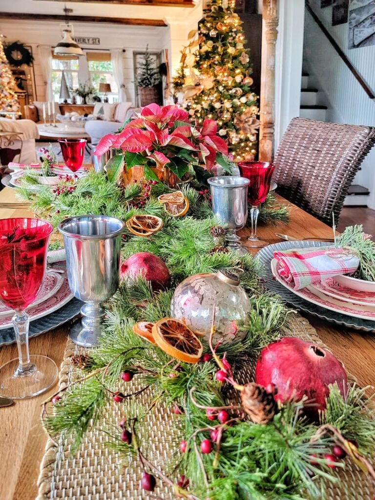 Cottage Christmas decor ideas: Christmas centerpiece with ornaments, greenery, pomegranates and dried oranges