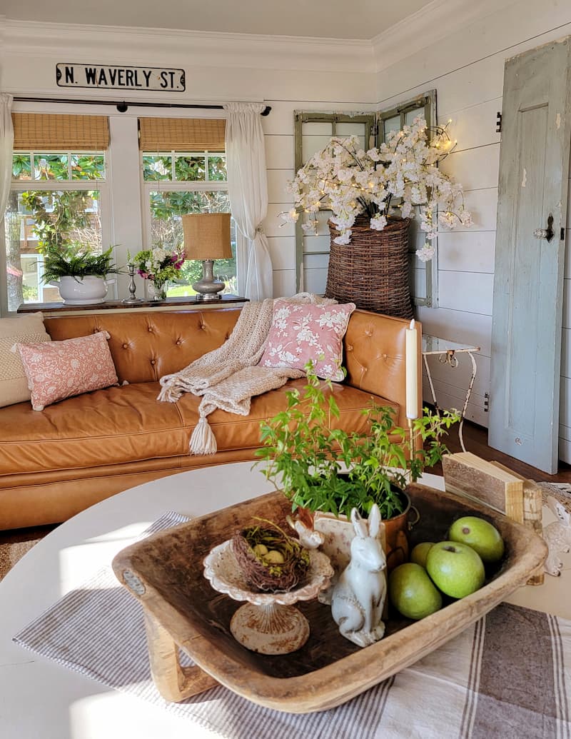 cottage living room decorated for spring with pink and white accents