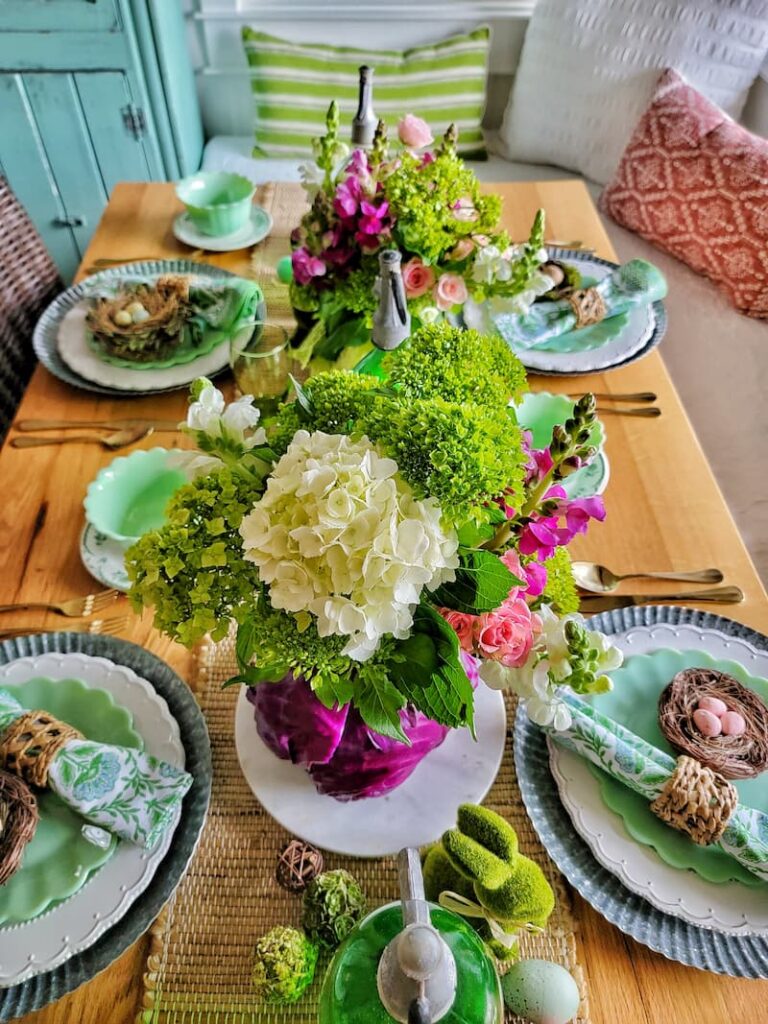 tablescape including cabbage vase with flowers for an Easter centerpiece