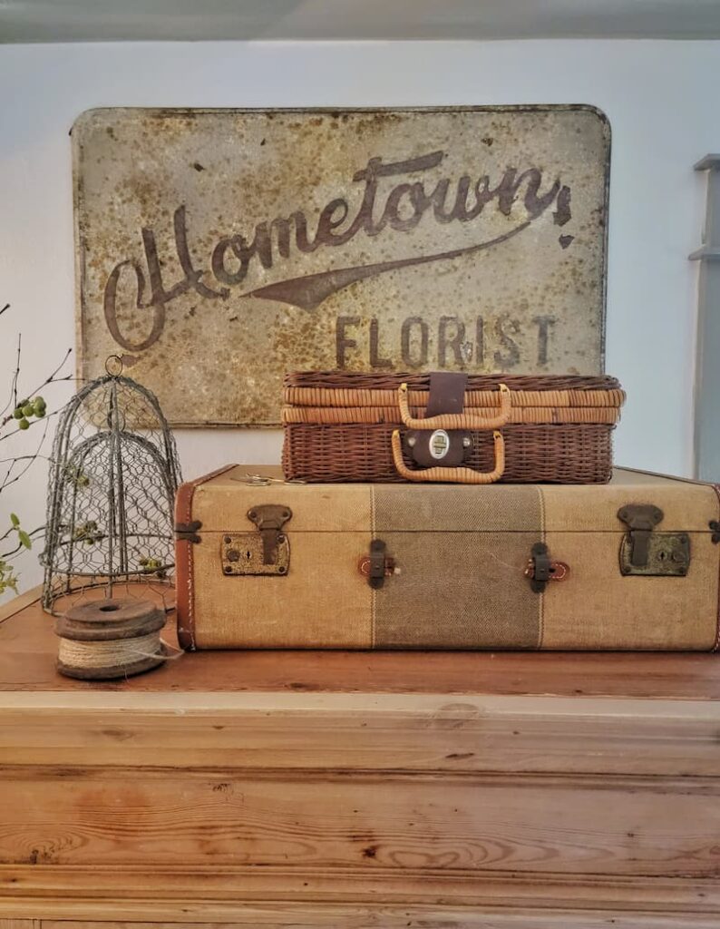 vintage suitcase and wicker picnic basket with sign