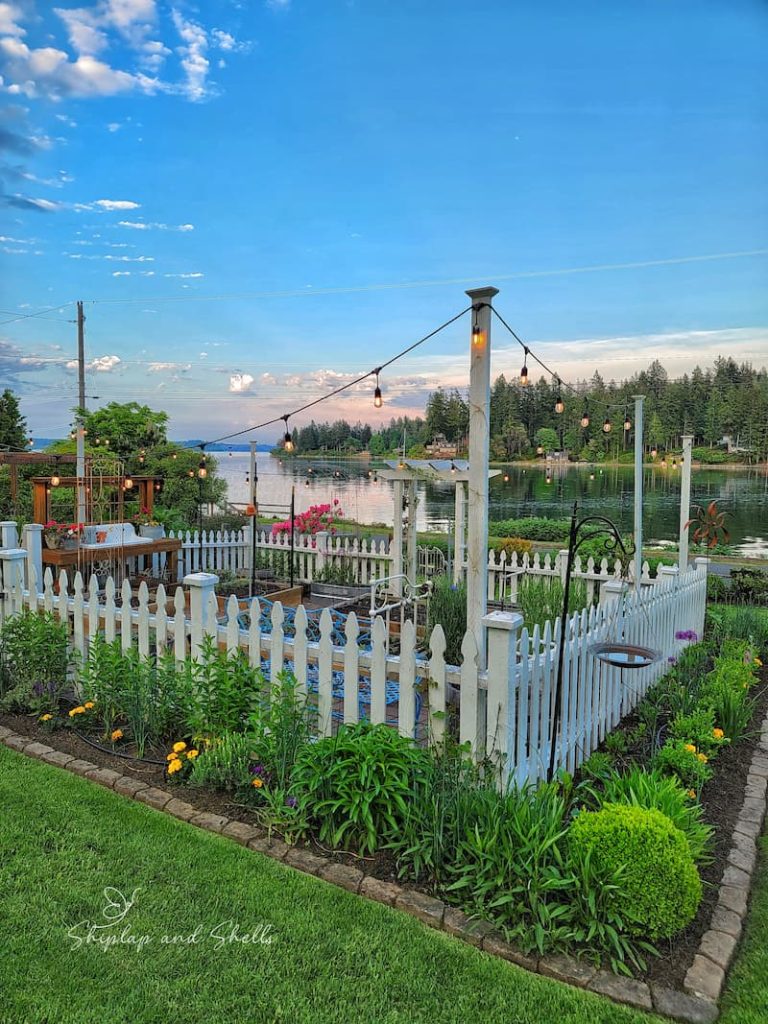 white picket fence garden overlooking the bay