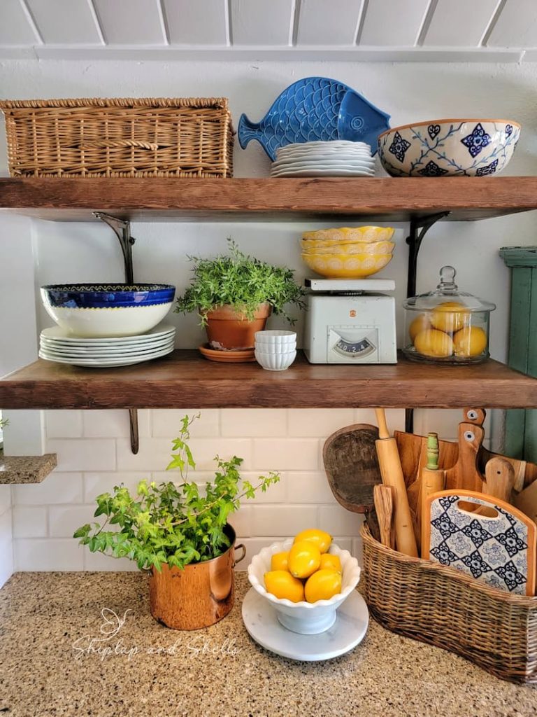 cottagecore kitchen decor: open shelves with greenery, lemons and vintage collections