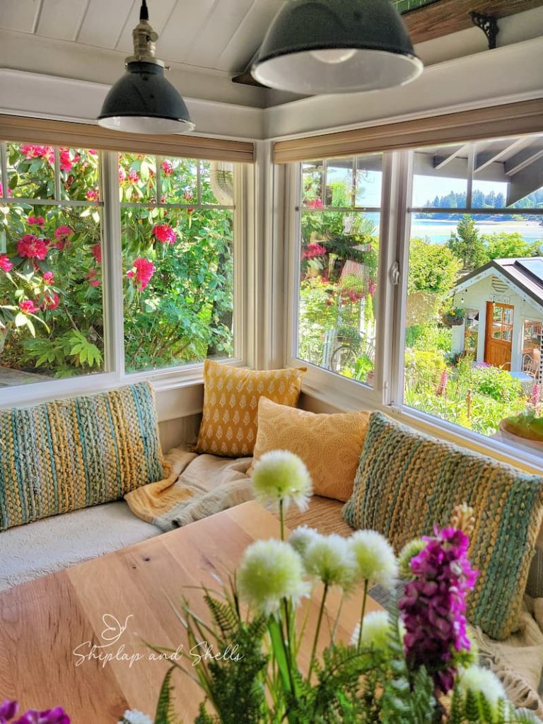 Summer coastal beach cottage kitchen with yellow and aqua pillows on window seat
