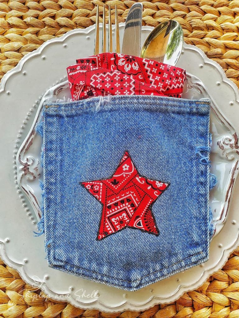 table setting with white dishes and a denim pocket with red bandana star
