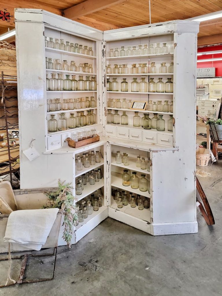white vintage cabinet and glass jars