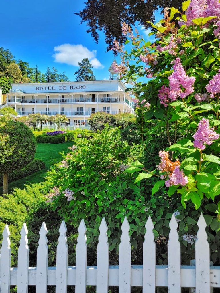 Hotel de Haro hotel and formal gardens with white picket fence and lilac