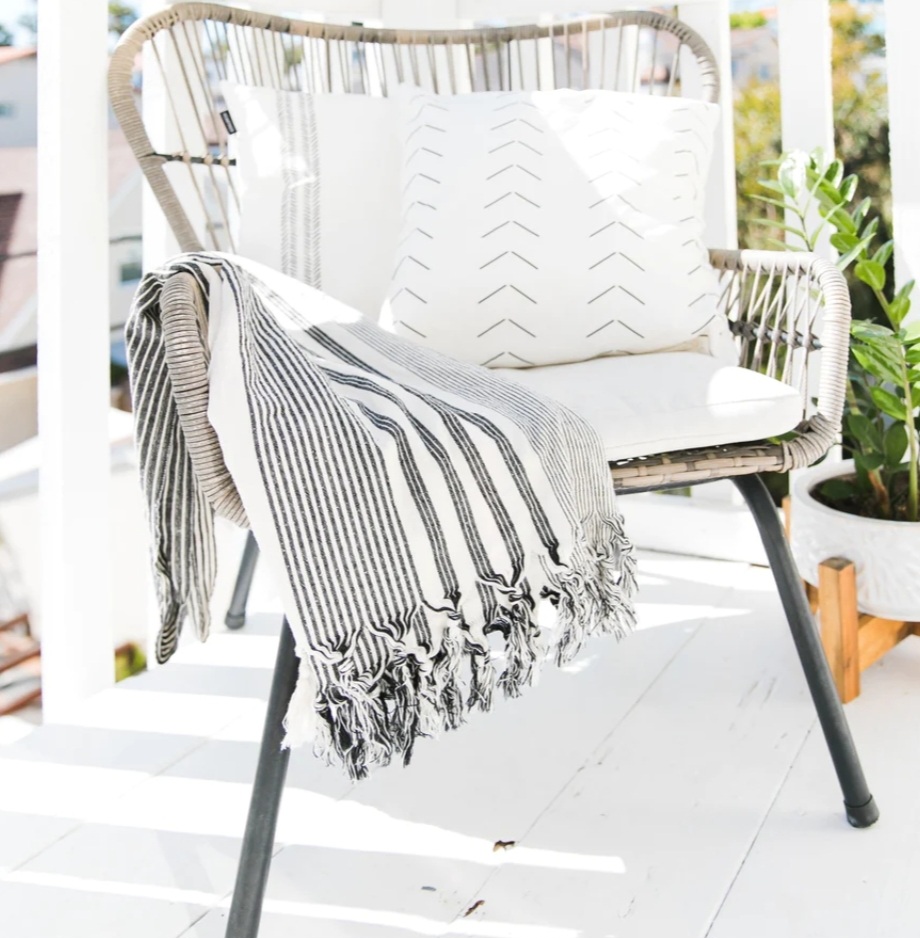 chair with white and black The Loomia beach towel