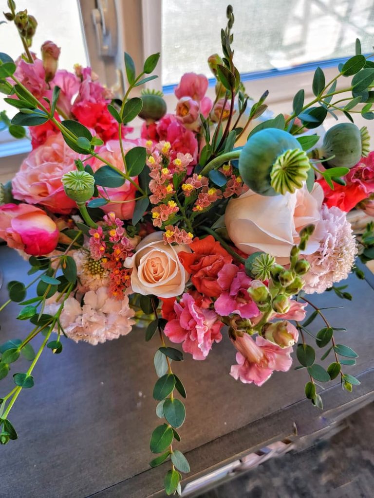 extend the life of cut flowers:  pink flowers and greenery in vase