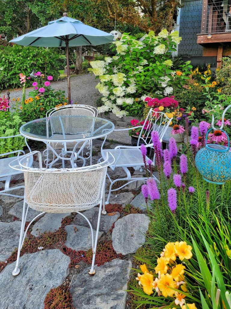 white iron table and chair set in the garden patio