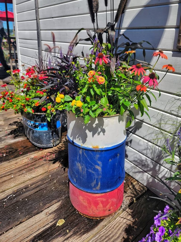 red, white, and blue rustic outdoor containers with flowers                                               
