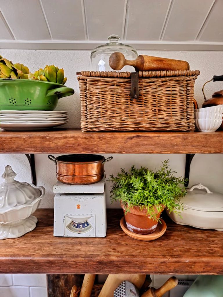 vintage decor items on open shelving in kitchen