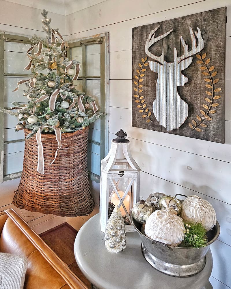wicker hanging basket with Christmas tree, reindeer head sign, and Christmas vignettes