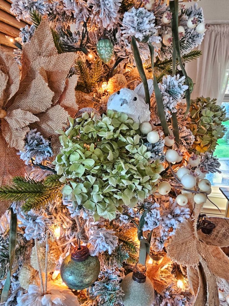 green hydrangea, white berries, white bird and burlap poinsettias on Christmas tree